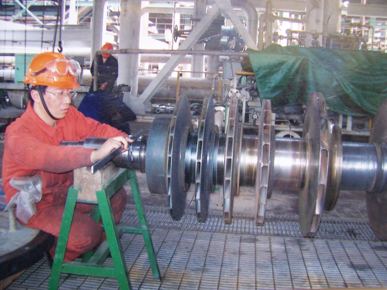 Technician inspecting a centrifugal compressor rotor