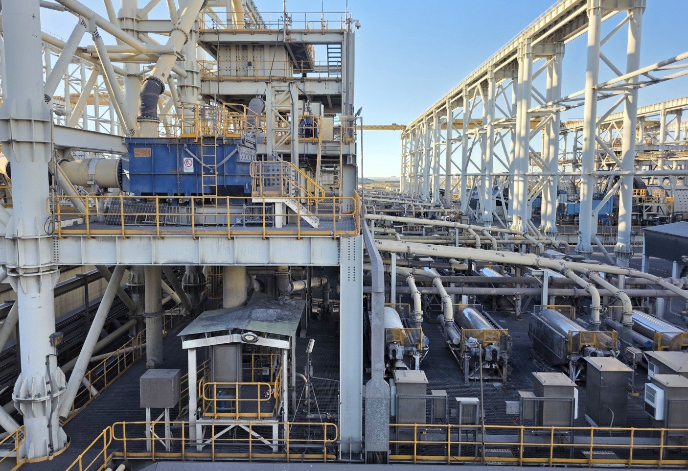 Open-pit mine and conveyor at sunset