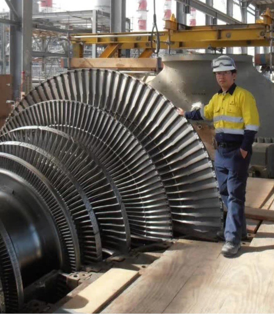 Chen Li inspecting a large steam turbine rotor